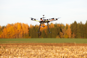 Drone taking off on field